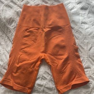 Alphalete orange biker shorts